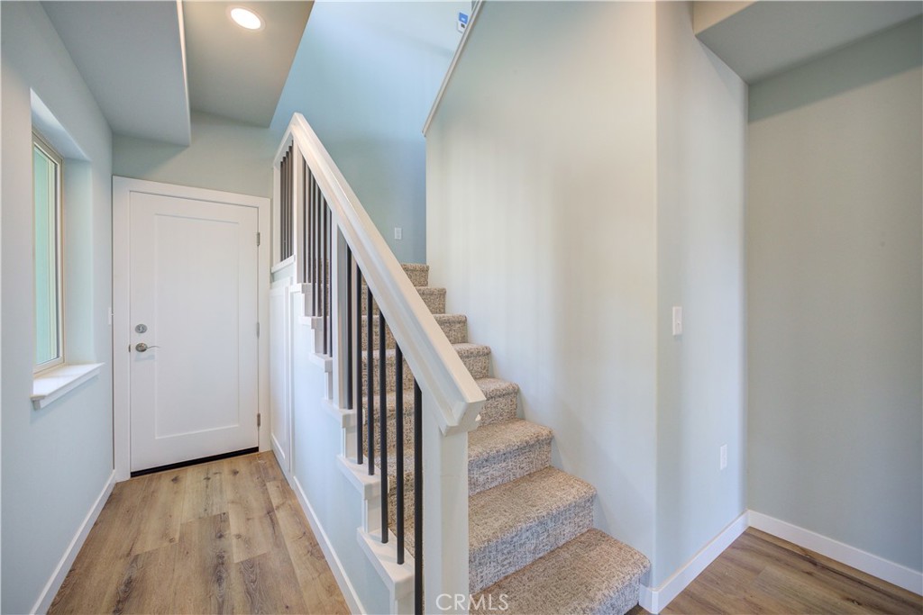 396 Castle Street Cambria, CA 93428 - Photo 44 of 74 a view of a hallway with wooden floor and entryway