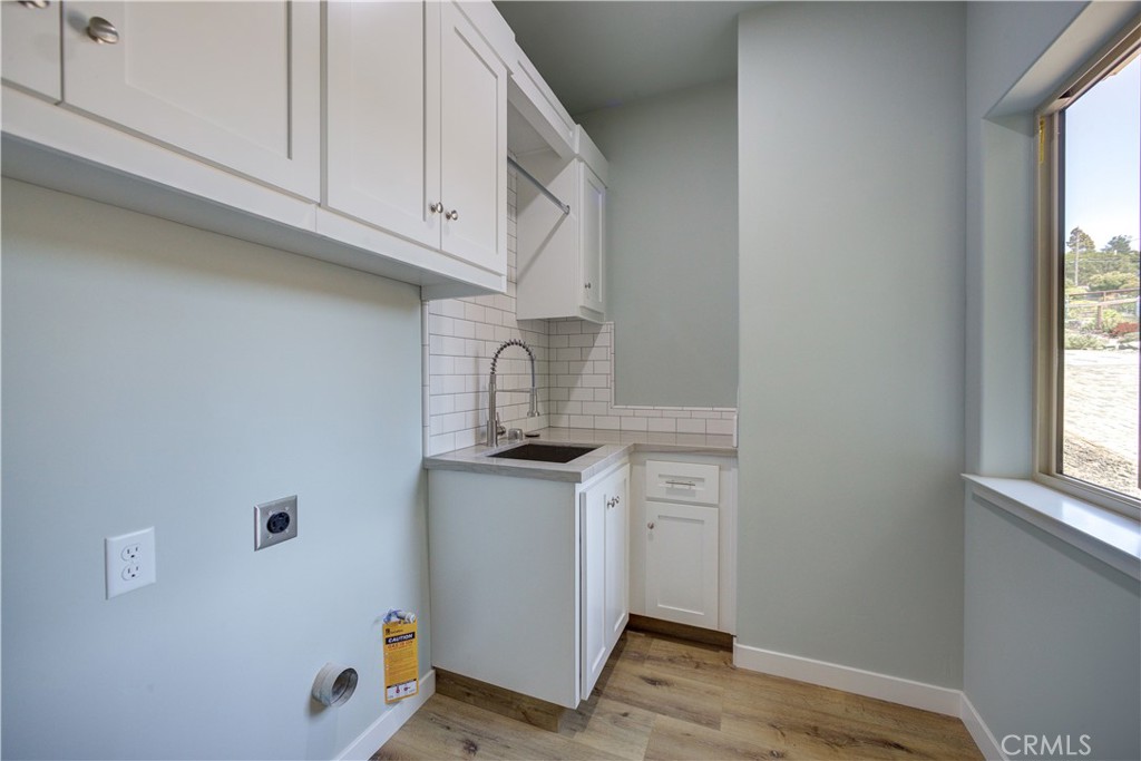 396 Castle Street Cambria, CA 93428 - Photo 45 of 74 a kitchen with stainless steel appliances granite countertop a sink and a stove