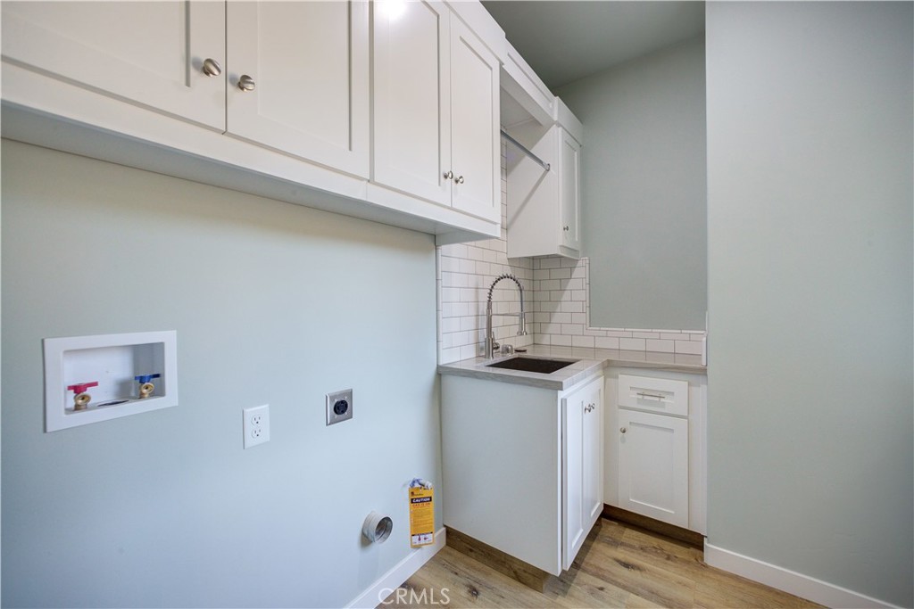 396 Castle Street Cambria, CA 93428 - Photo 46 of 74 a kitchen with stainless steel appliances a sink and cabinets