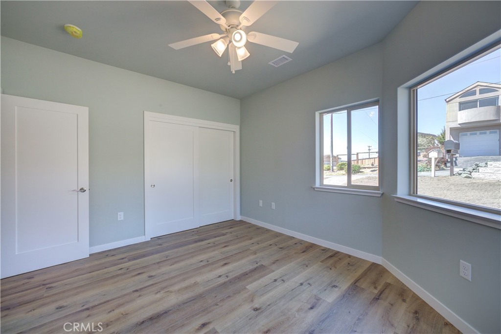 396 Castle Street Cambria, CA 93428 - Photo 49 of 74 wooden floor in an empty room with a window