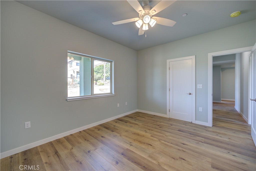 396 Castle Street Cambria, CA 93428 - Photo 59 of 74 a view of an empty room with wooden floor and a window