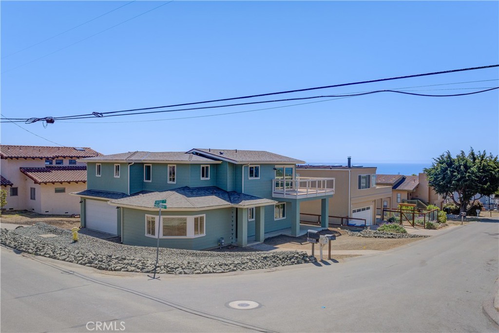 396 Castle Street Cambria, CA 93428 - Photo 60 of 74 a view of a patio with a table and chairs under an umbrella