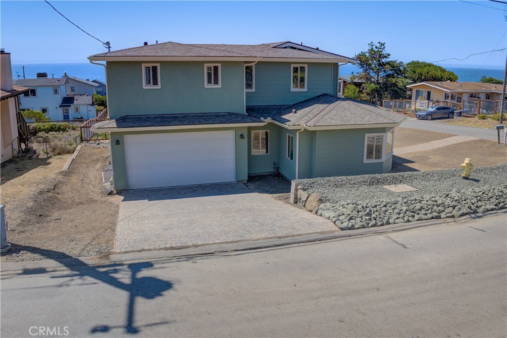 396 Castle Street Cambria, CA 93428 - Photo 67 of 74 a front view of a house with a yard and garage