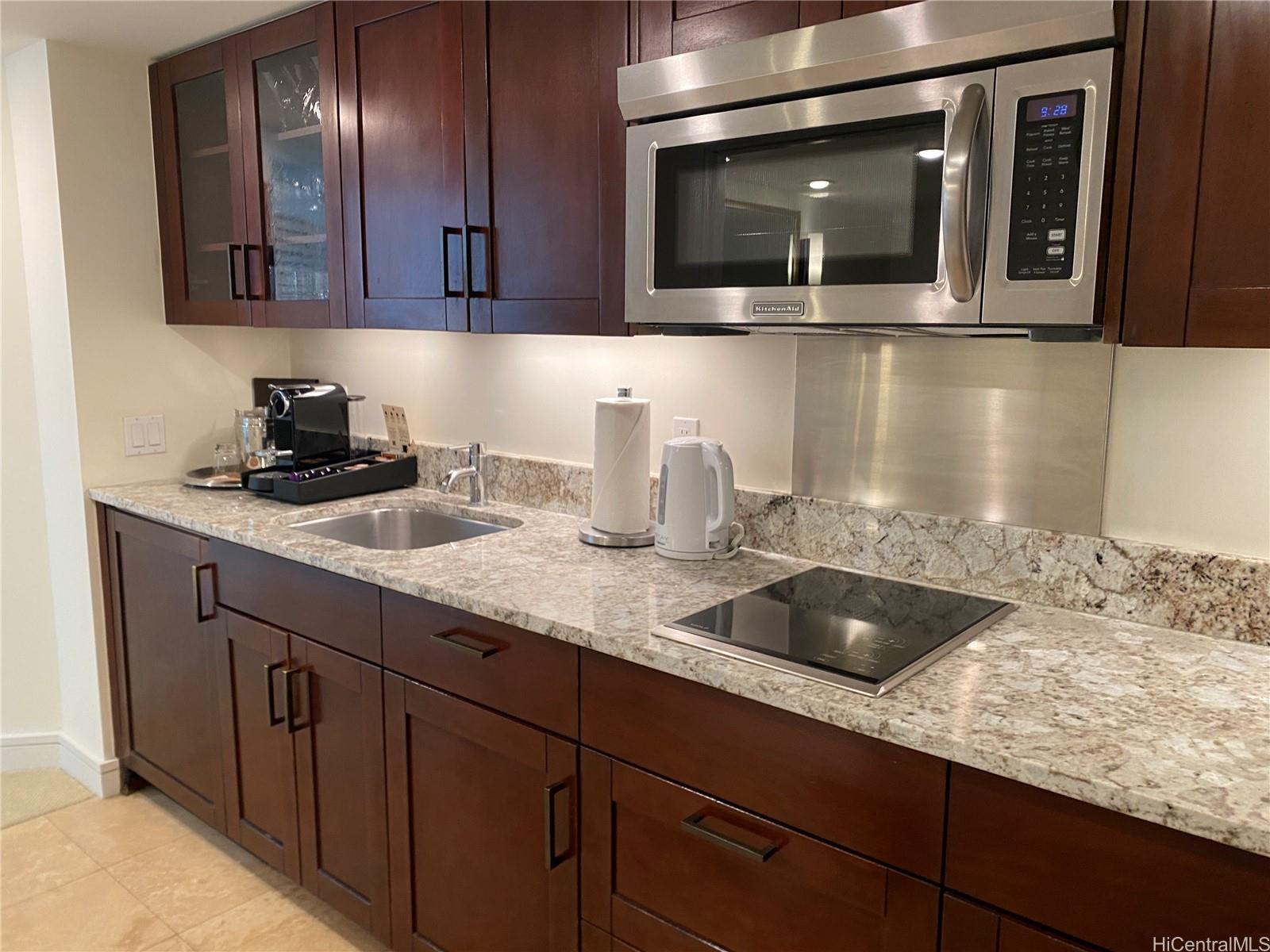 223 Saratoga Road, Unit 2316 Honolulu, HI 96815 - Photo 10 of 20 a kitchen with granite countertop stainless steel appliances a sink and cabinets