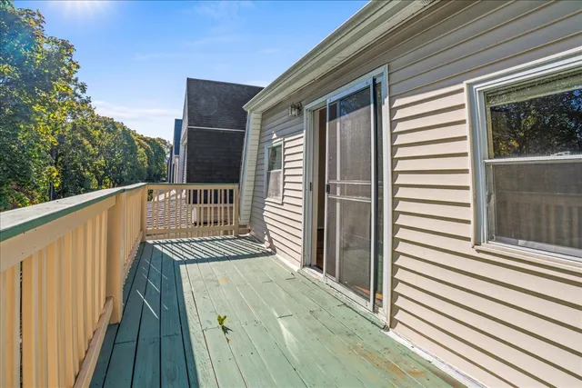 a view of a wooden balcony with wooden floor and fence