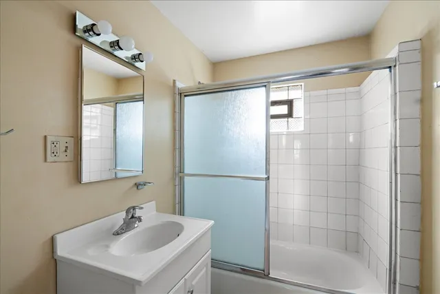 a bathroom with a shower and a sink
