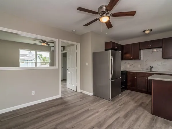 a kitchen with a refrigerator cabinet and a sink