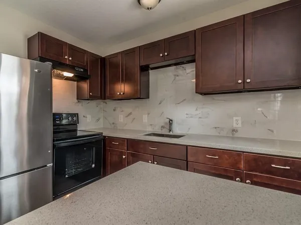 a kitchen with a sink and a refrigerator