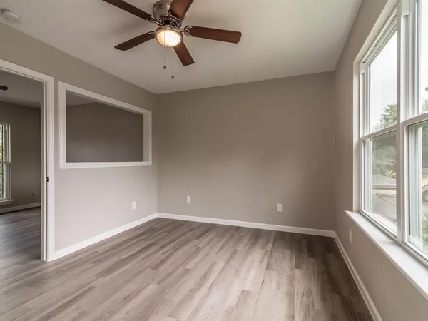 wooden floor in an empty room with a window