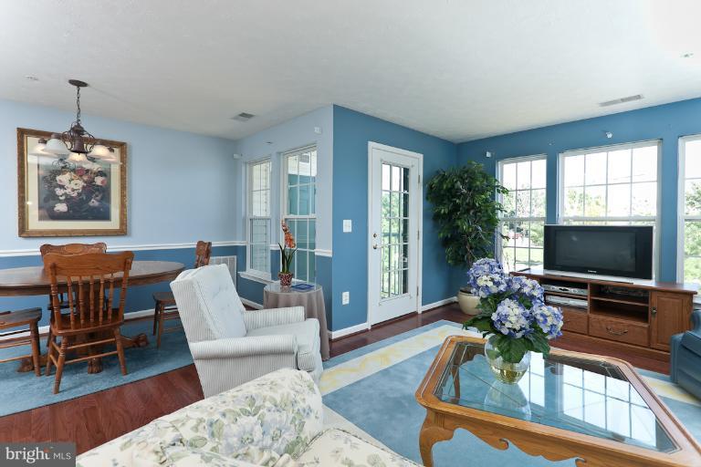 9604 Haven Farm Road, Unit 9604F Perry Hall, MD 21128 - Photo 2 of 19 a living room with furniture a flat screen tv and a large window