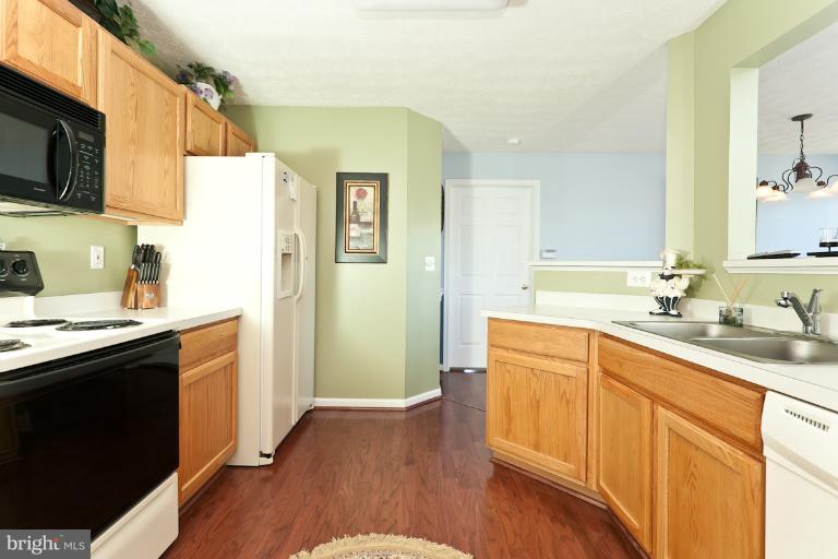 9604 Haven Farm Road, Unit 9604F Perry Hall, MD 21128 - Photo 11 of 19 a kitchen with stainless steel appliances a sink dishwasher stove refrigerator and microwave