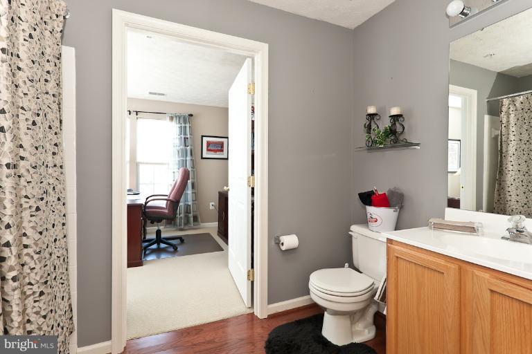 9604 Haven Farm Road, Unit 9604F Perry Hall, MD 21128 - Photo 19 of 19 a bathroom with a sink toilet and a mirror