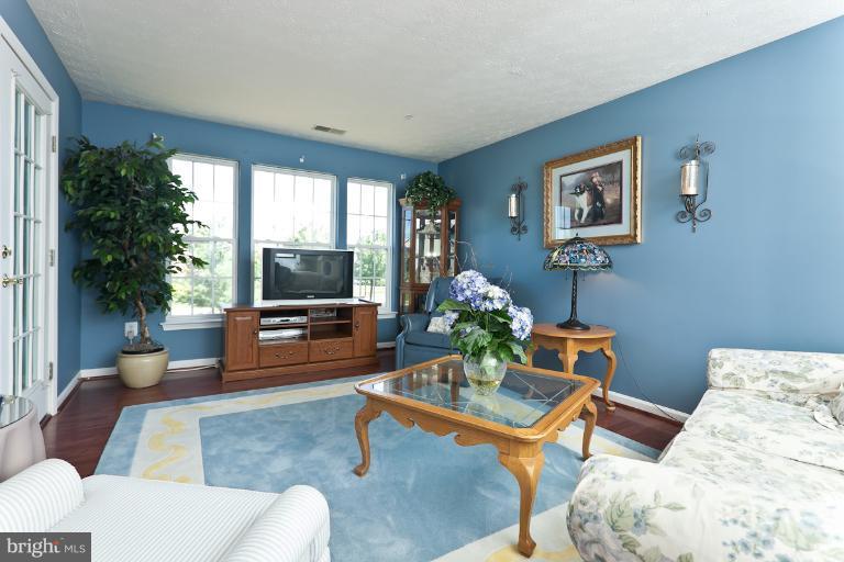 9604 Haven Farm Road, Unit 9604F Perry Hall, MD 21128 - Photo 3 of 19 a living room with furniture and a flat screen tv