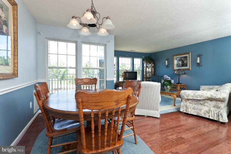 9604 Haven Farm Road, Unit 9604F Perry Hall, MD 21128 - Photo 4 of 19 a view of a dining room with furniture window and wooden floor