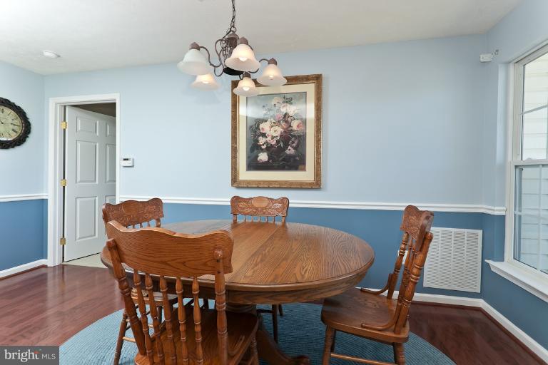 9604 Haven Farm Road, Unit 9604F Perry Hall, MD 21128 - Photo 8 of 19 a view of a dining room with furniture wooden floor and a chandelier