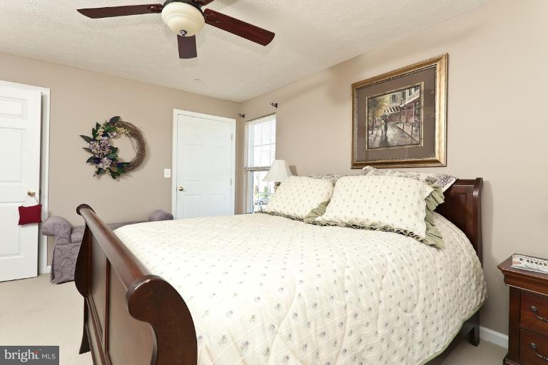 9604 Haven Farm Road, Unit 9604F Perry Hall, MD 21128 - Photo 10 of 19 a bedroom with a bed and a chandelier