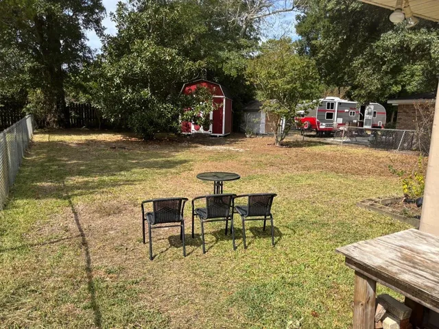 a swimming pool with outdoor seating and yard