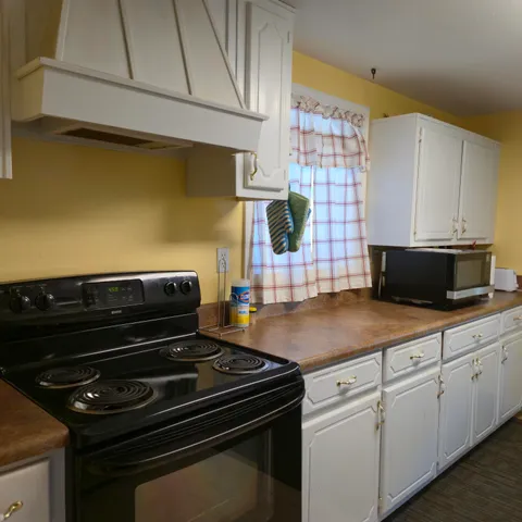 a kitchen with a stove and a microwave