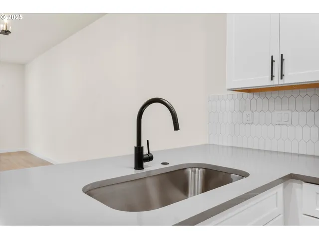 a view of an empty room with a fireplace and a window