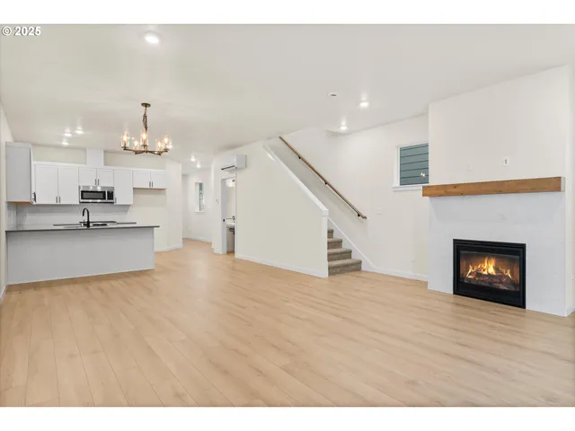 a living room with a fireplace and a wooden floor