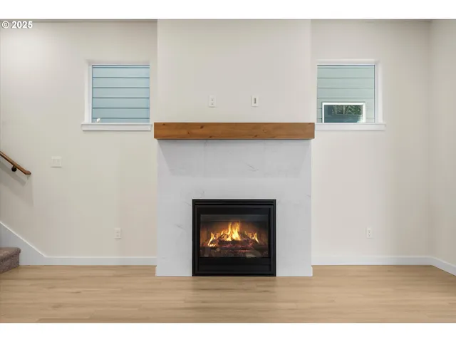 a kitchen with stainless steel appliances granite countertop a sink a stove a refrigerator and white cabinets