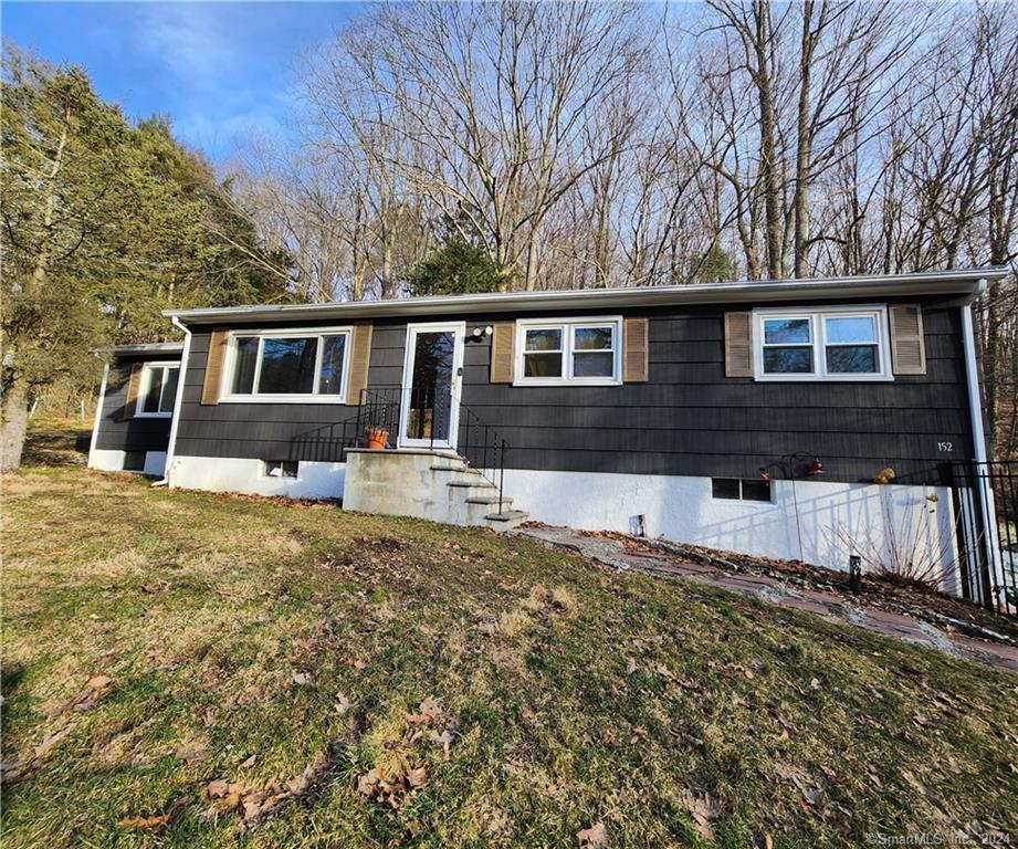 152 Redding Road Redding, CT 06896 - Photo 1 of 1 a front view of a house with a yard