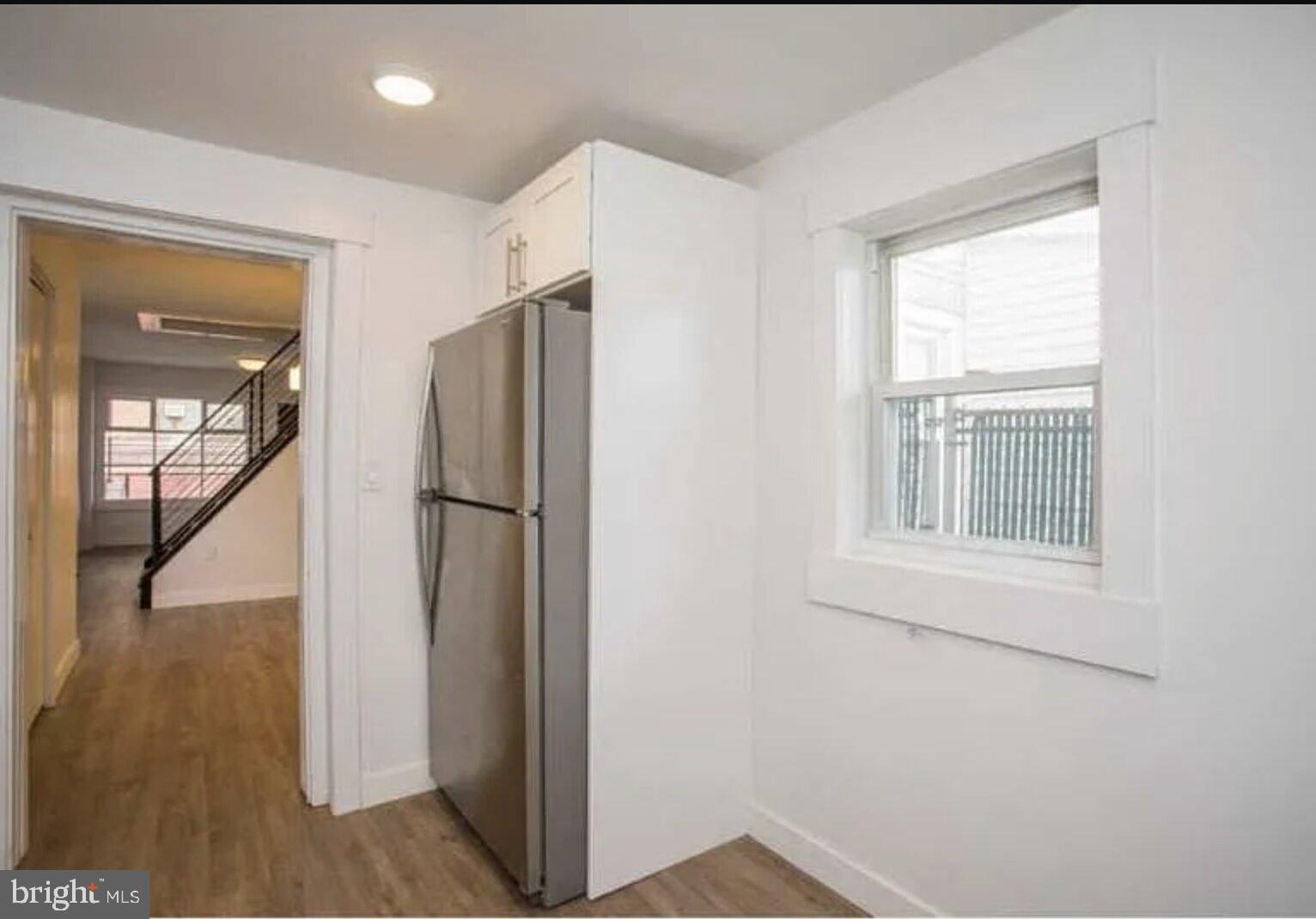 5 Coates Street Bridgeport, PA 19405 - Photo 6 of 28 a view of an empty room with wooden floor and a window