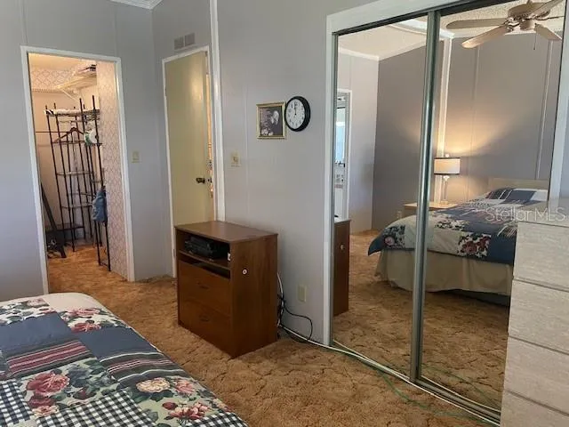 a bedroom with a bed and a mirror