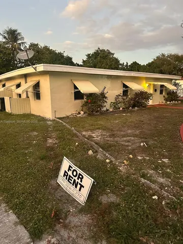 a view of a fire pit with trees in the background