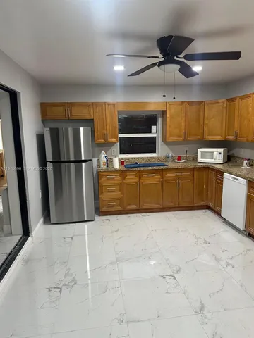 en empty room with windows and fireplace