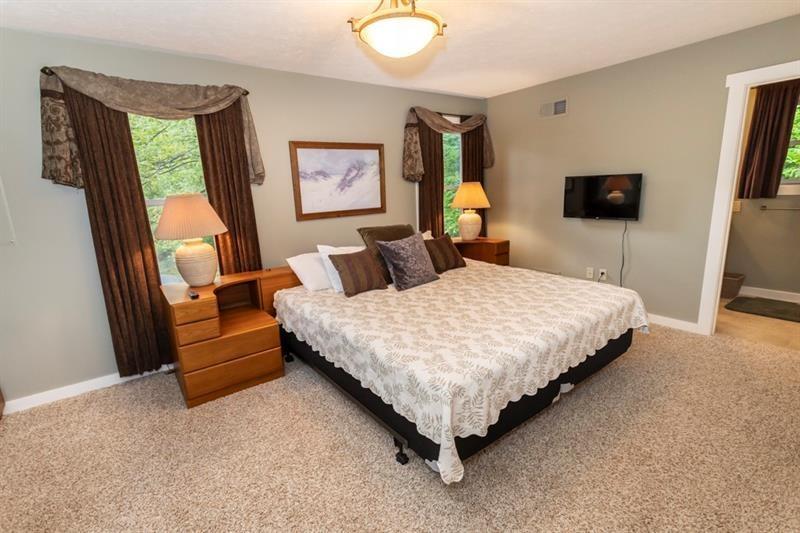 2226 County Line Road Champion, PA 15622 - Photo 28 of 33 a bedroom with a bed a couch and a flat screen tv
