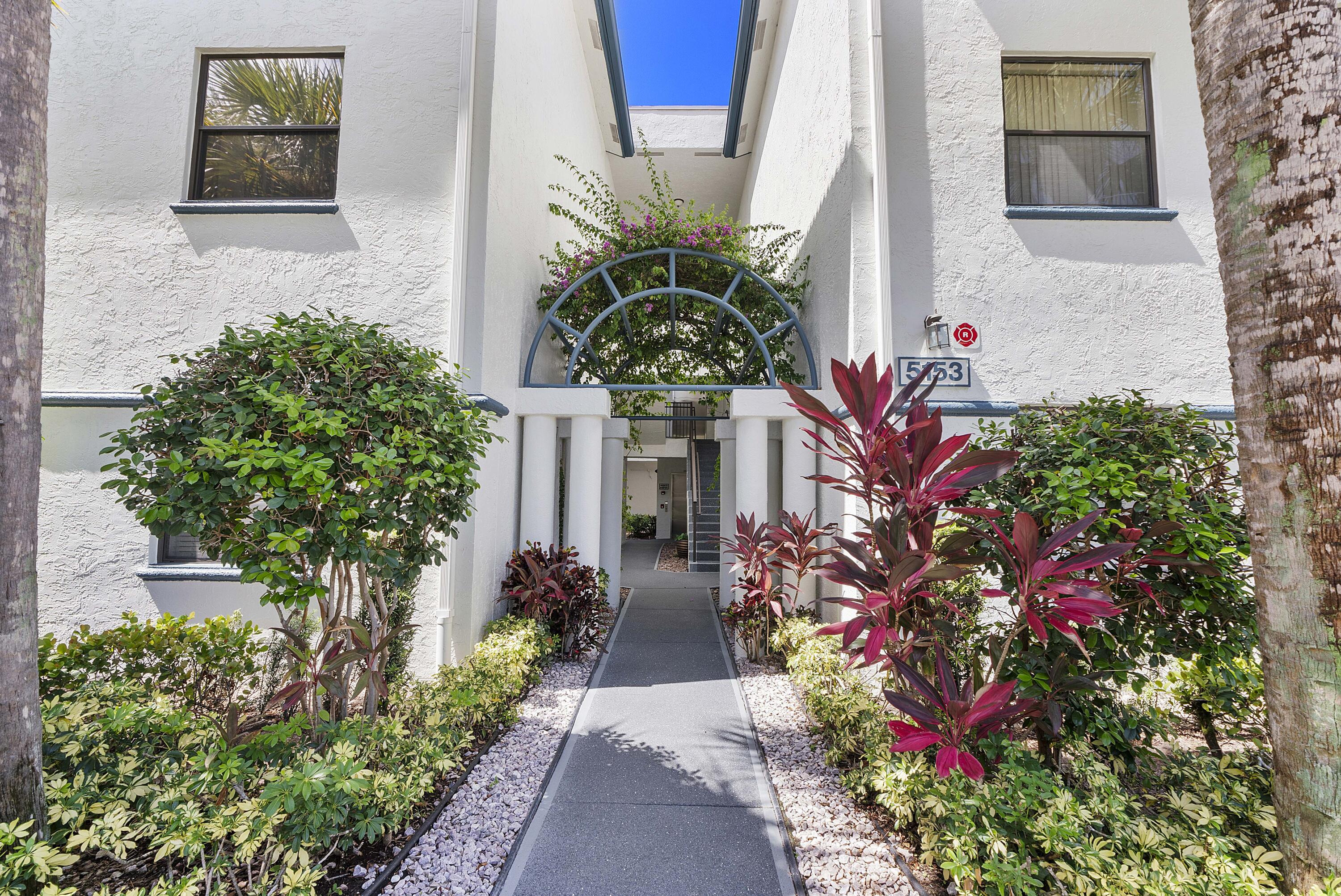 5153 Floria Drive, Unit V Boynton Beach, FL 33437 - Photo 1 of 39 a vase with flowers sitting on a floor in front of a door