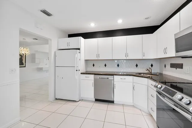 a kitchen with cabinets and appliances
