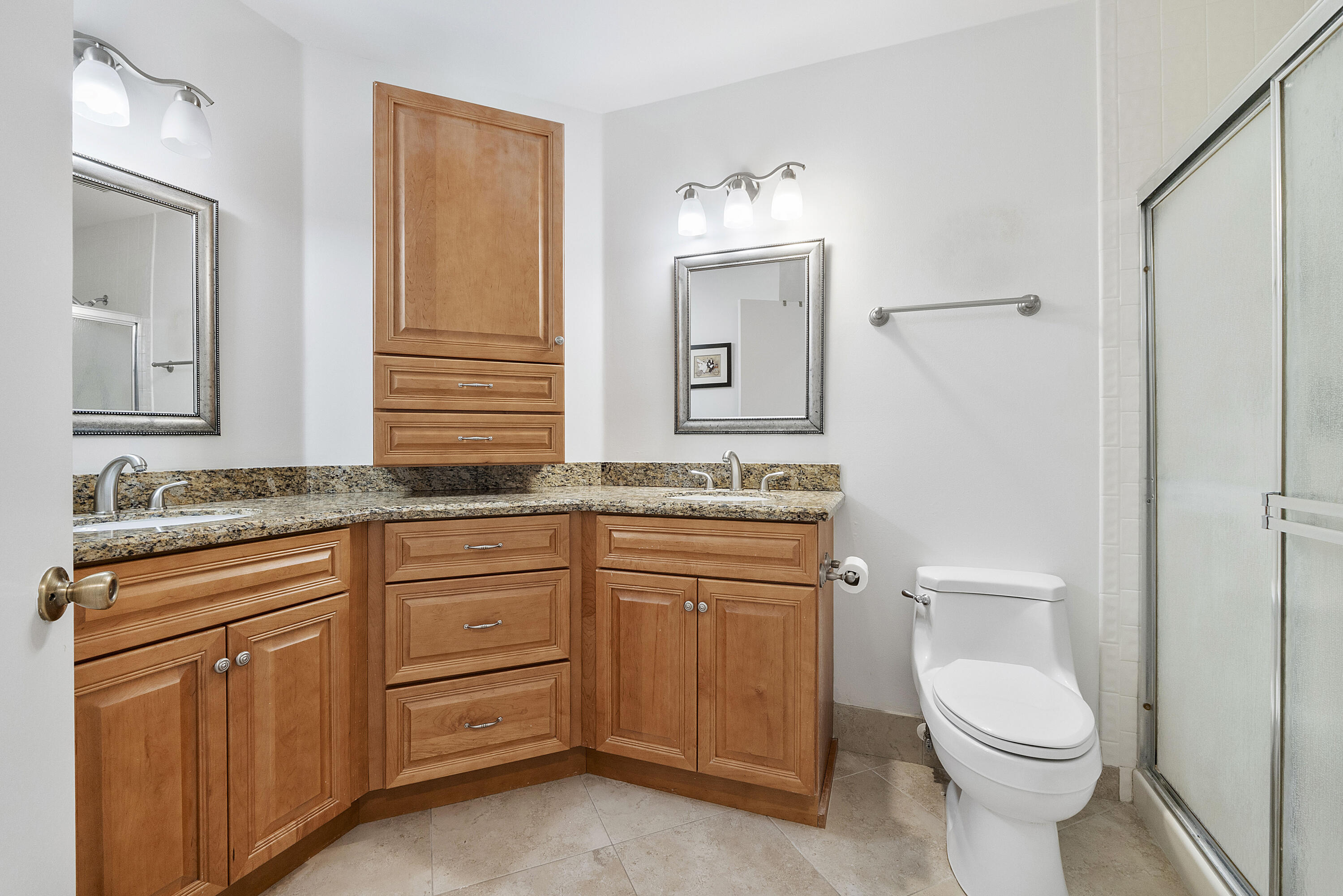 5153 Floria Drive, Unit V Boynton Beach, FL 33437 - Photo 15 of 39 a bathroom with a granite countertop toilet sink and mirror