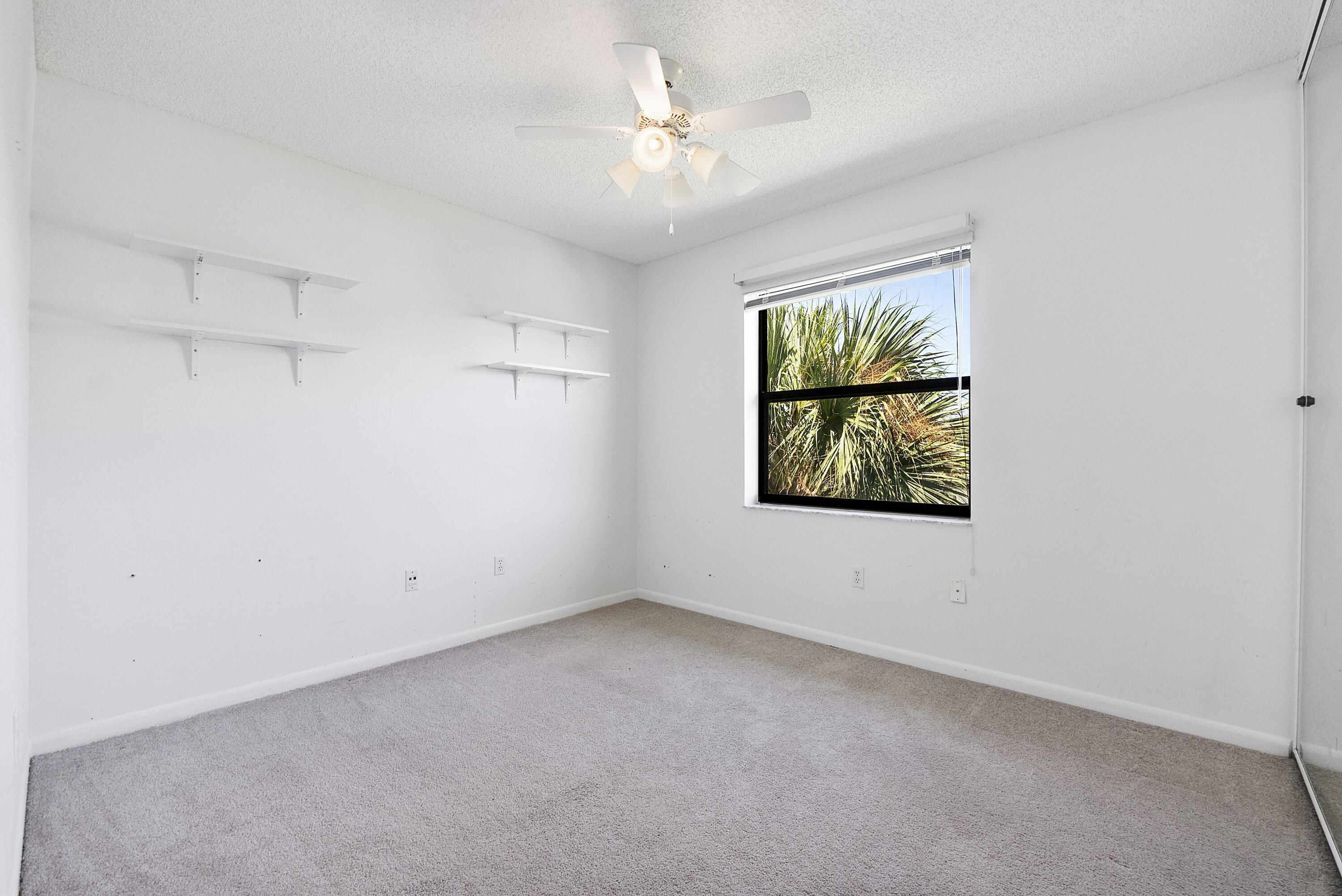 5153 Floria Drive, Unit V Boynton Beach, FL 33437 - Photo 17 of 39 an empty room with windows and fan