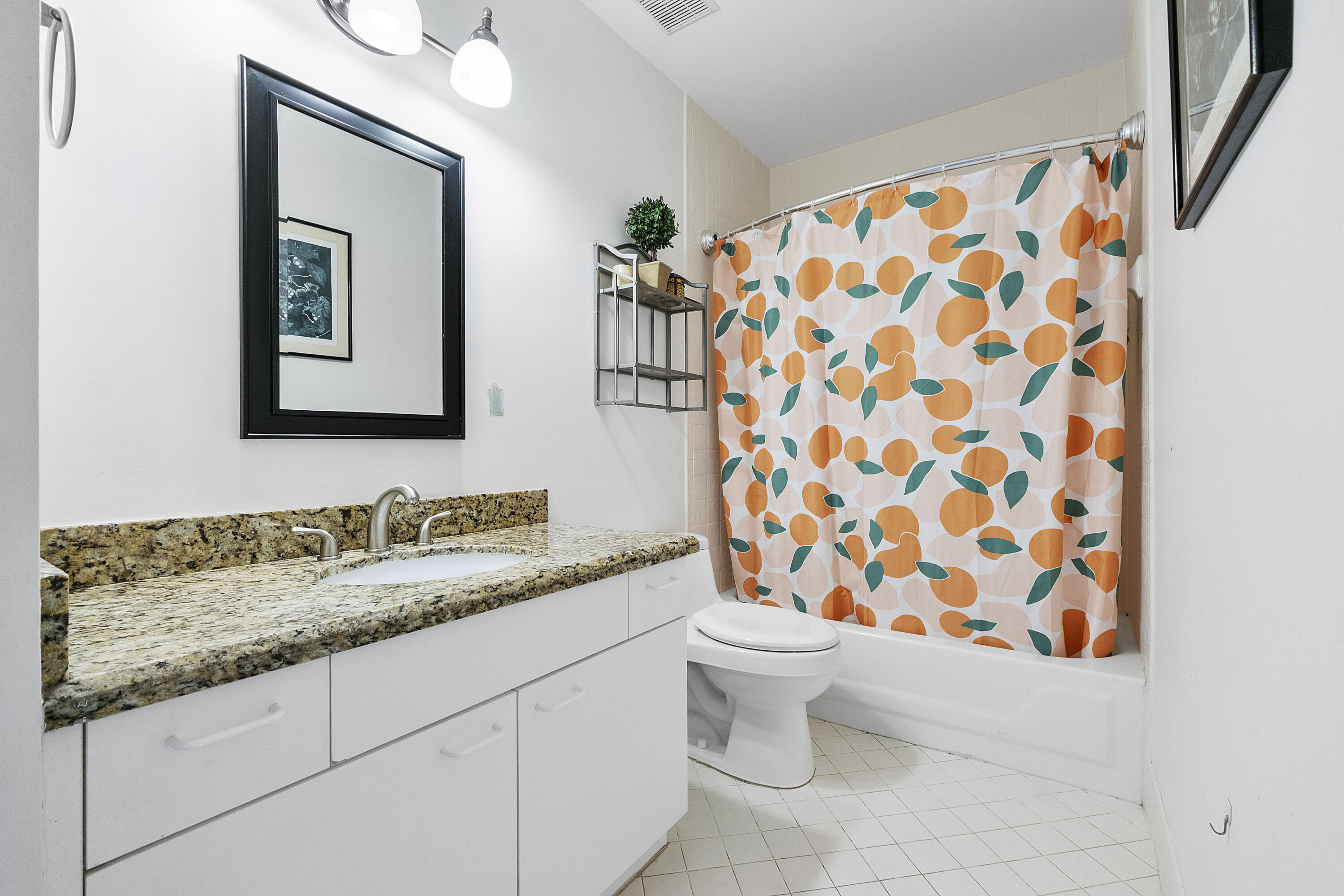 5153 Floria Drive, Unit V Boynton Beach, FL 33437 - Photo 21 of 39 a bathroom with a granite countertop sink and a mirror