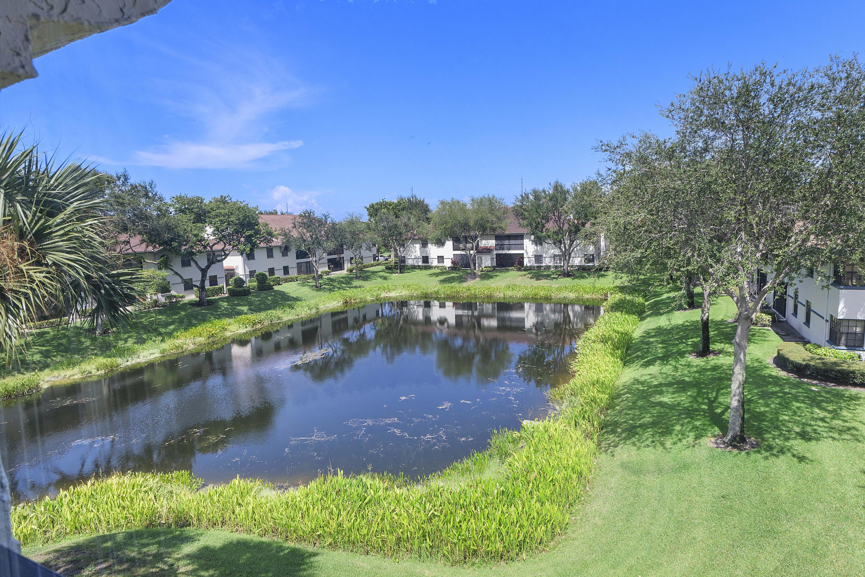 5153 Floria Drive, Unit V Boynton Beach, FL 33437 - Photo 24 of 39 a view of a lake with a yard