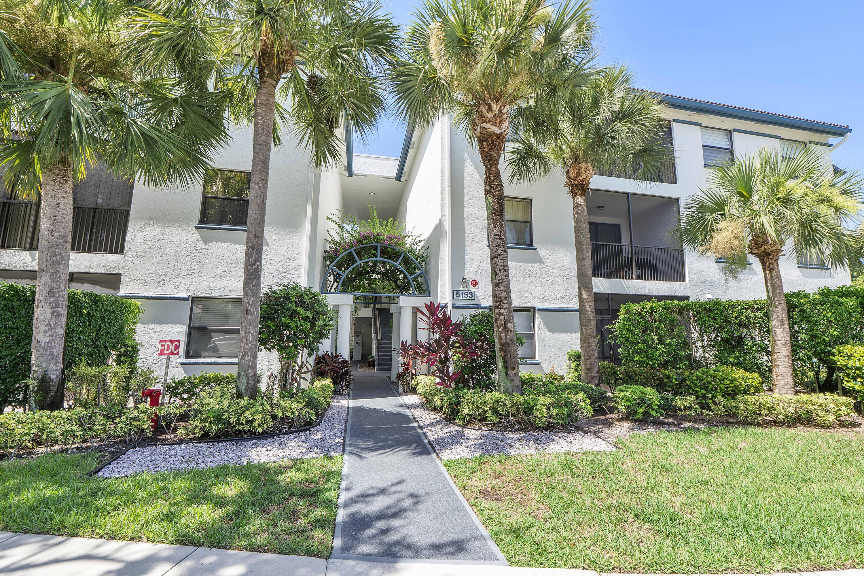 5153 Floria Drive, Unit V Boynton Beach, FL 33437 - Photo 25 of 39 a front view of house and yard with green space