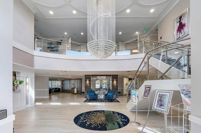 a room with lots of furniture and a chandelier