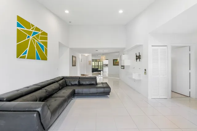 a living room with furniture and kitchen