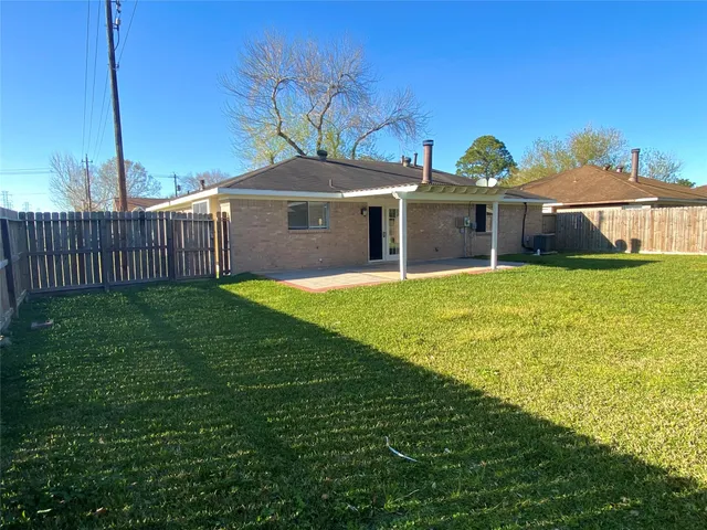 a view of a house with a yard and a porch