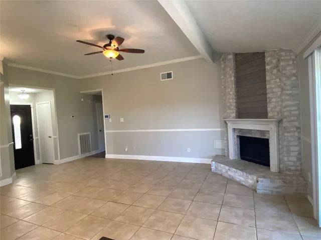 a view of an empty room with a fireplace