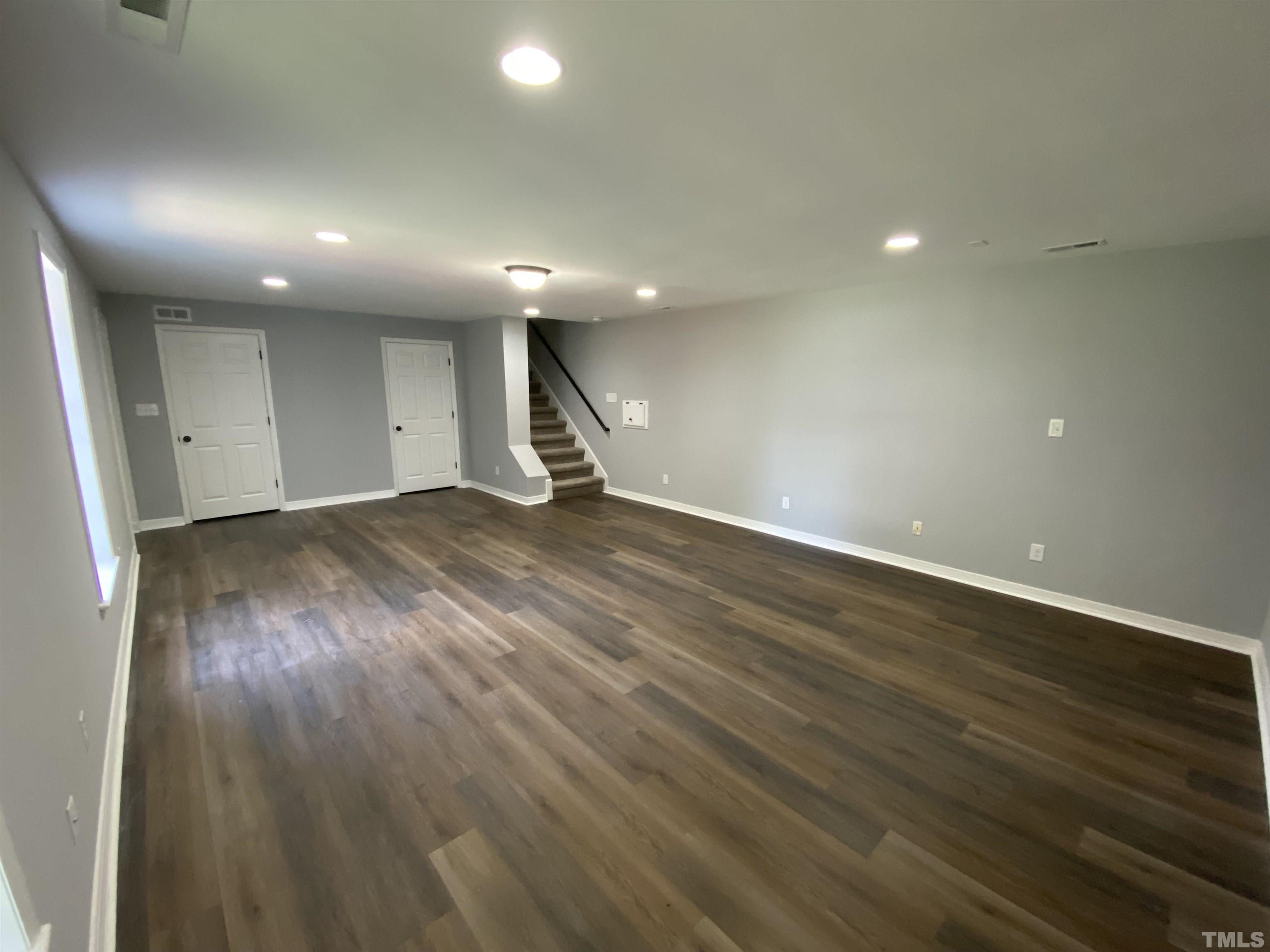 4815 Elmhurst Ridge Court Raleigh, NC 27616 - Photo 24 of 25 an empty room with wooden floor and windows