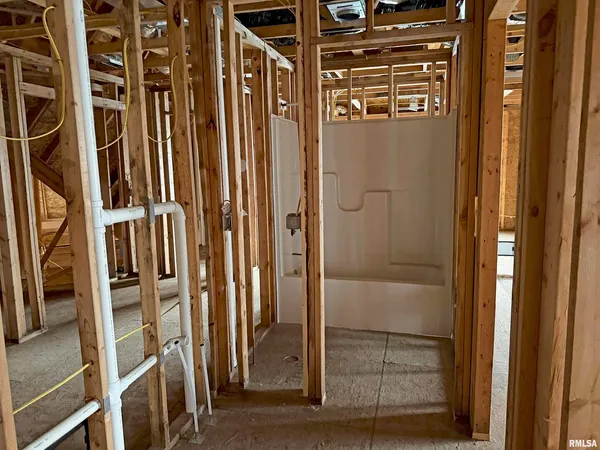a view of a room with wooden walls and stairs