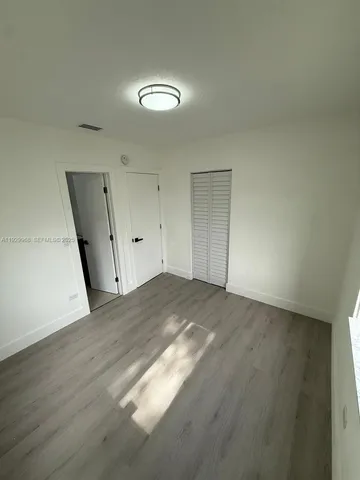 a bathroom with a toilet sink vanity and shower