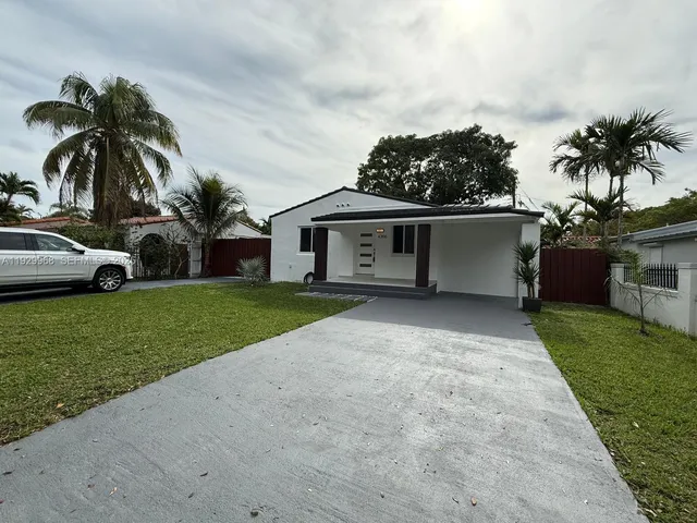 a view of house with outdoor space and car parked