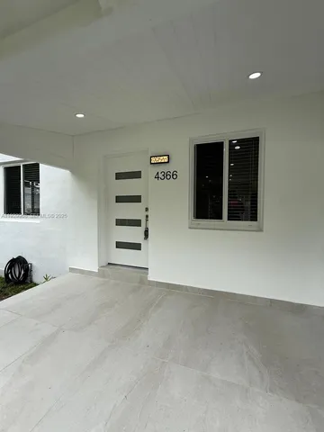 an empty room with a fireplace and window