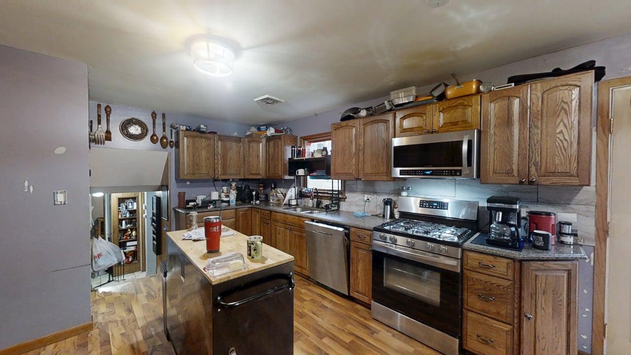 2308 Slayback Street Urbana, IL 61802 - Photo 12 of 37 a kitchen with granite countertop a sink dishwasher stove and microwave with wooden floor