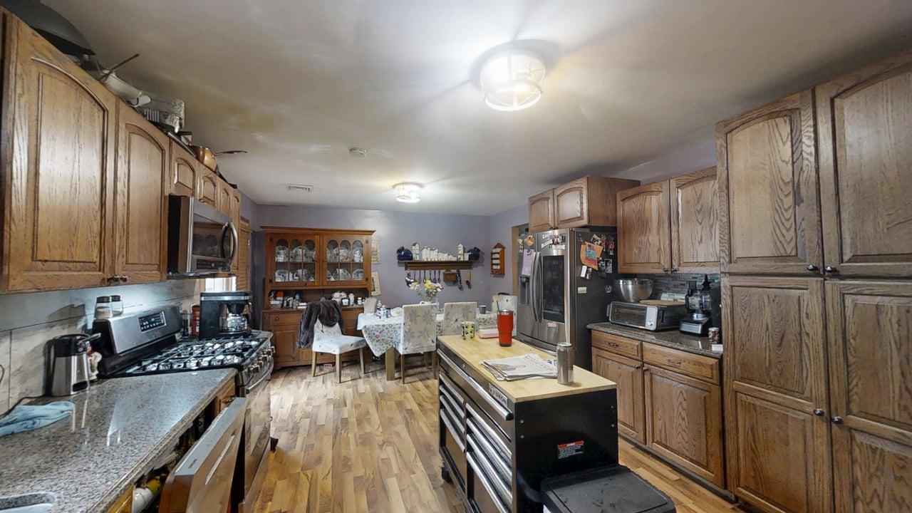 2308 Slayback Street Urbana, IL 61802 - Photo 13 of 37 a kitchen with stainless steel appliances granite countertop a refrigerator a sink dishwasher a stove and white countertops with wooden floor