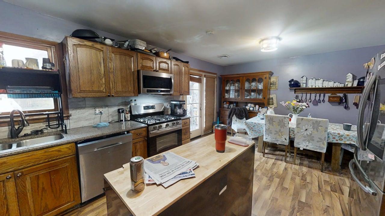 2308 Slayback Street Urbana, IL 61802 - Photo 14 of 37 a kitchen with stainless steel appliances granite countertop a stove top oven a sink dishwasher and cabinets with wooden floor
